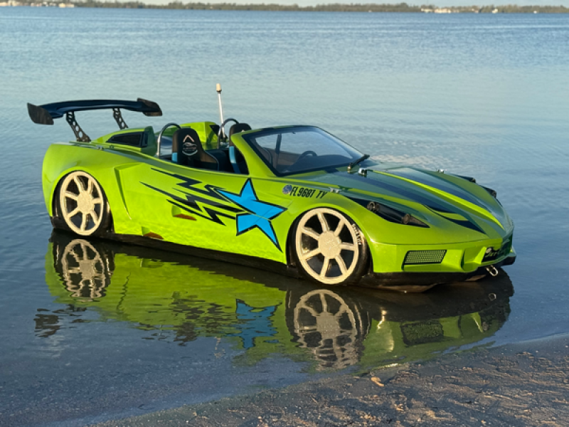 Lime green sports car in shallow water