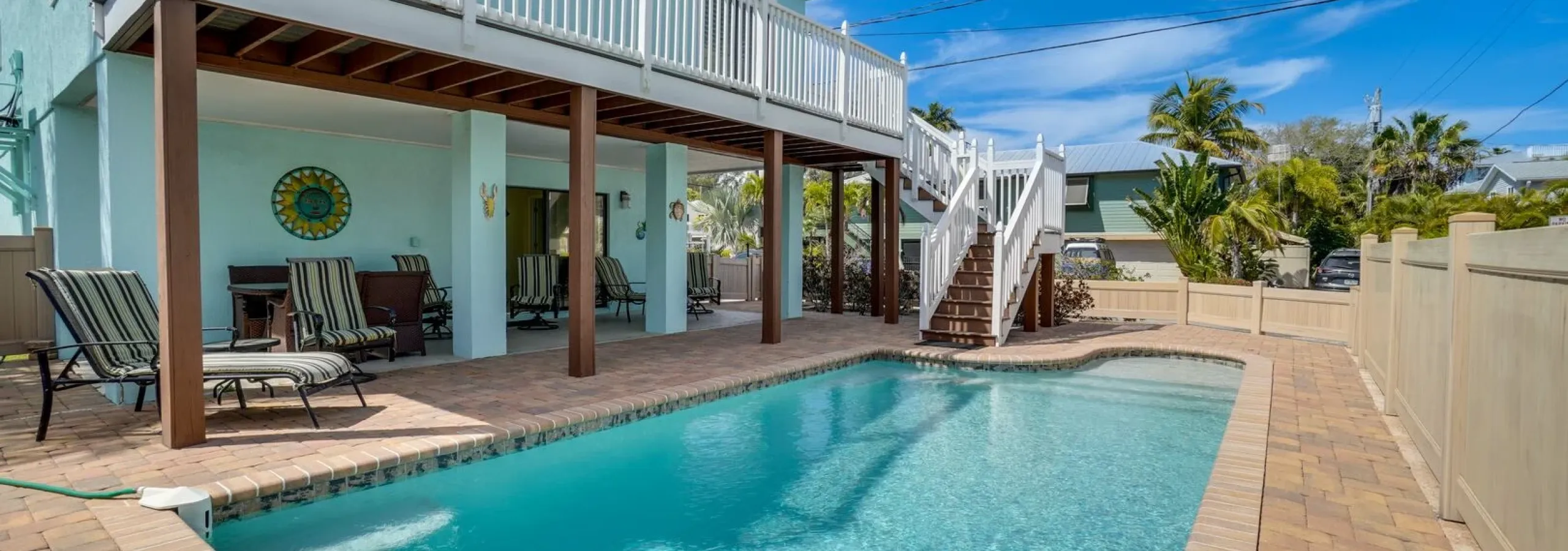 Vacation rental with turquoise pool and beachfront deck