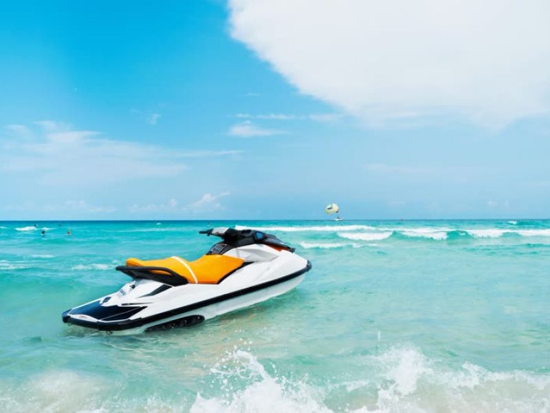 Yellow and black jet ski in clear turquoise tropical water