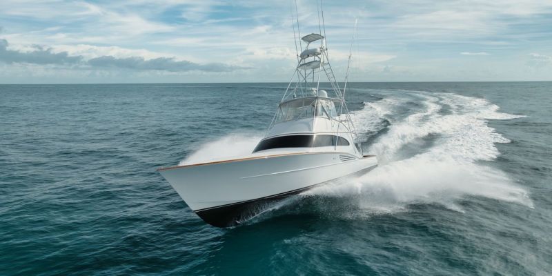 White sport fishing boat moving through water