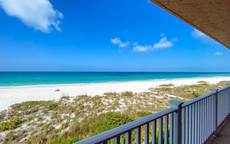 Balcony railing view of beach and coastline