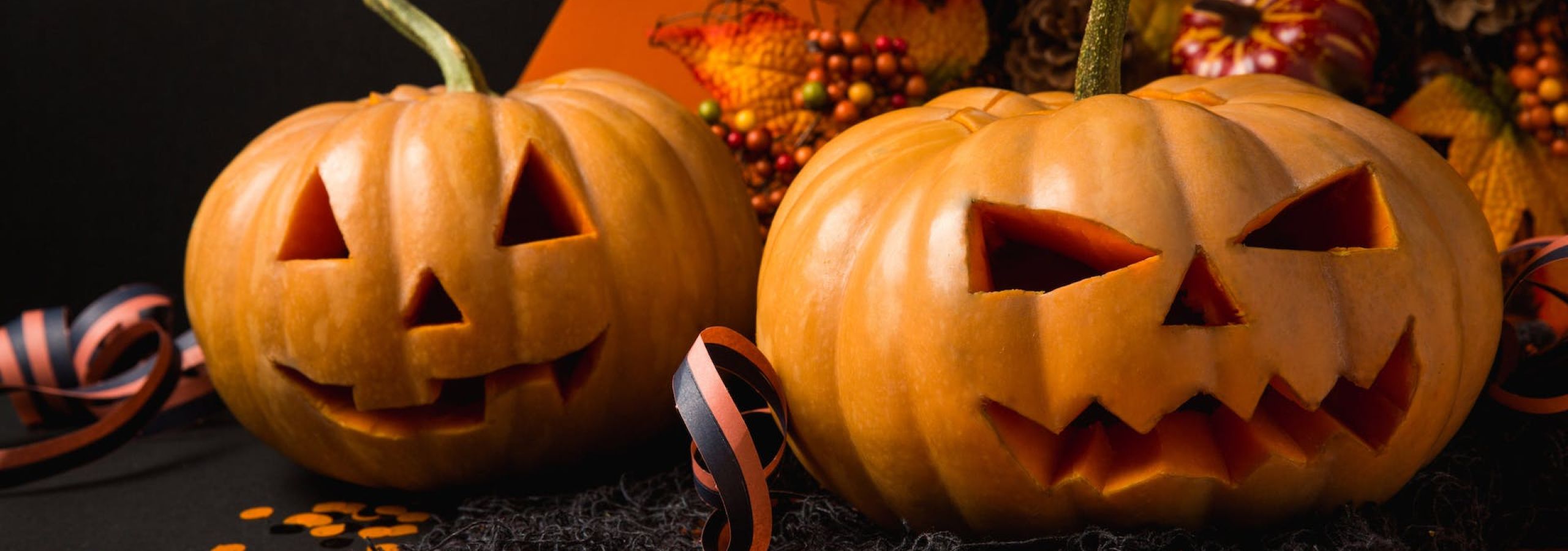 Carved jack-o'-lantern pumpkins with Halloween decorations