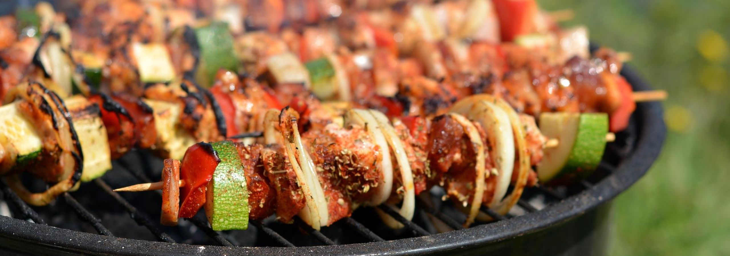 Meat and vegetable kebabs on grill