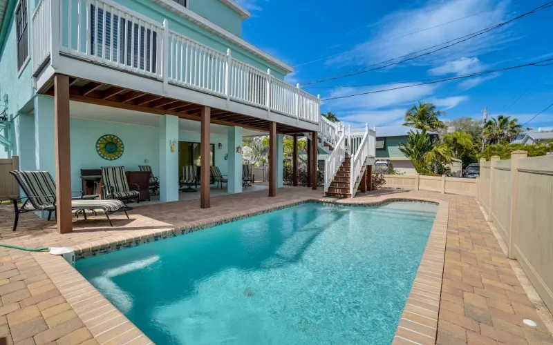 Vacation rental with turquoise pool and beachfront deck