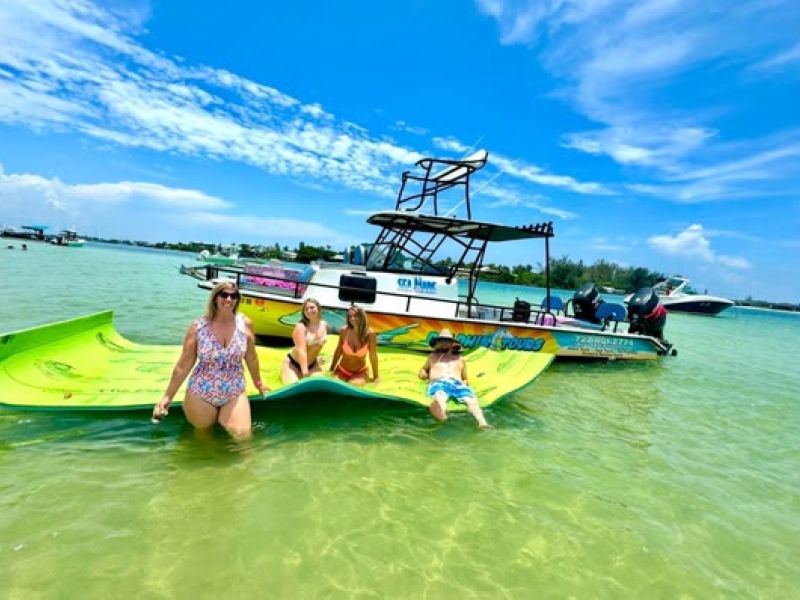 Fishermen on colorful boat in clear shallow coastal water