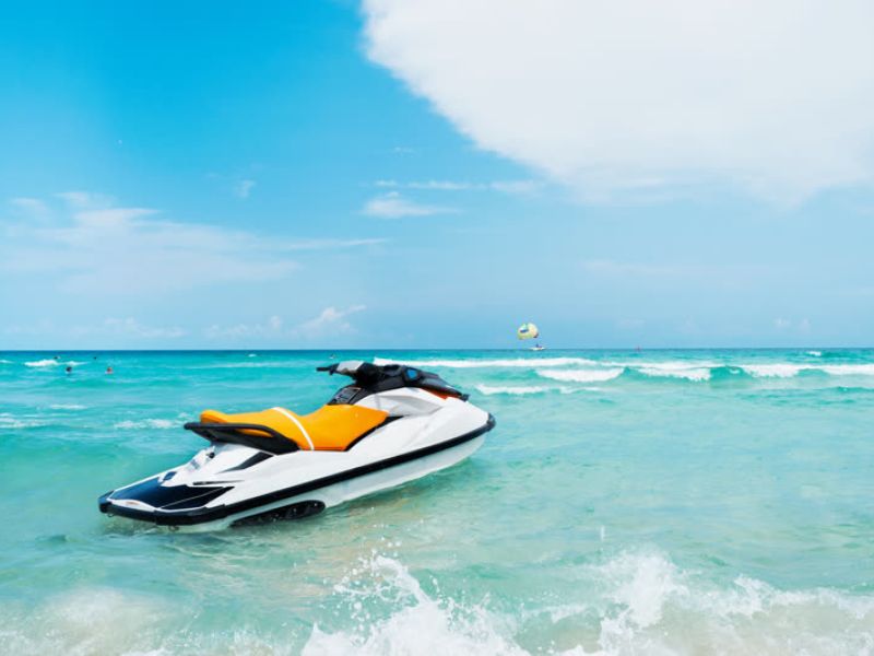 Yellow and black jet ski in clear turquoise tropical water