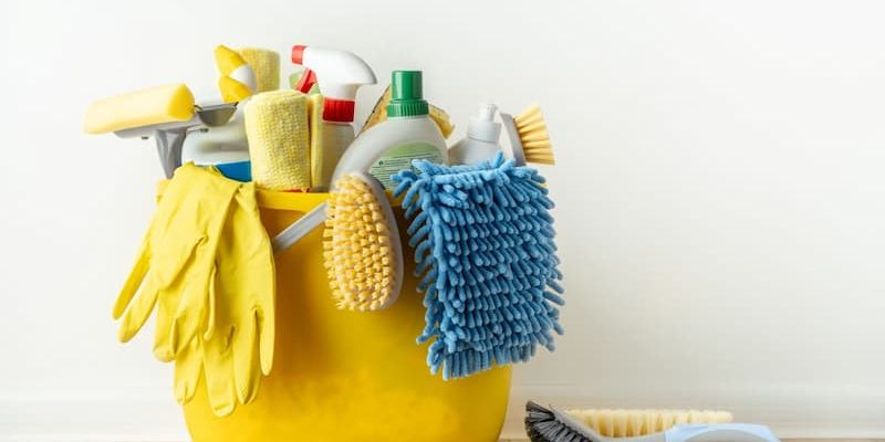 Yellow cleaning bucket with supplies and tools
