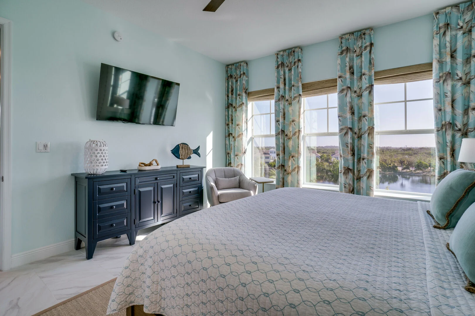 View of large bedroom overlooking water at seabreeze vacation's coastal bliss rental in Anna Maria Island Florida