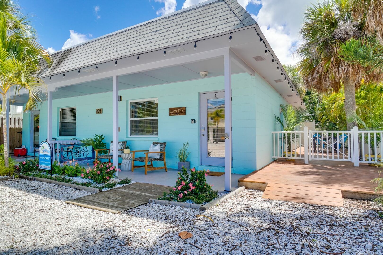 Charming light blue vacation home with white railing