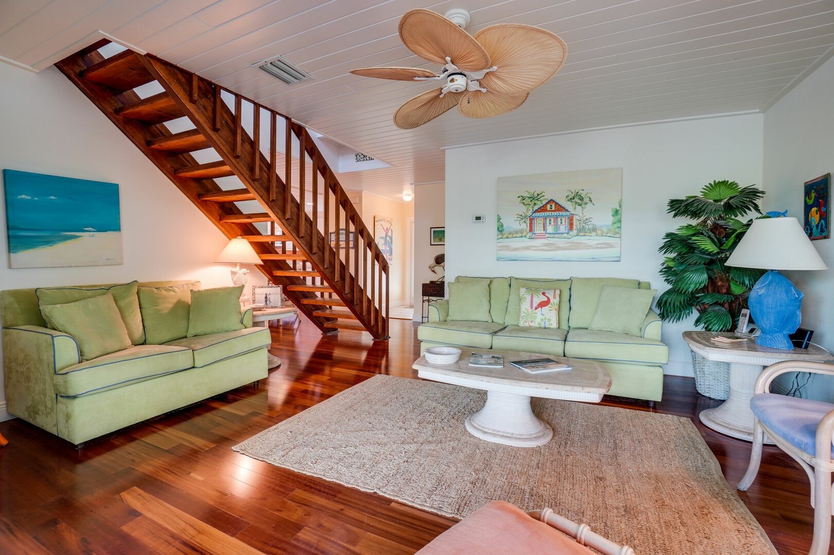 Open living room with wooden staircase and furniture