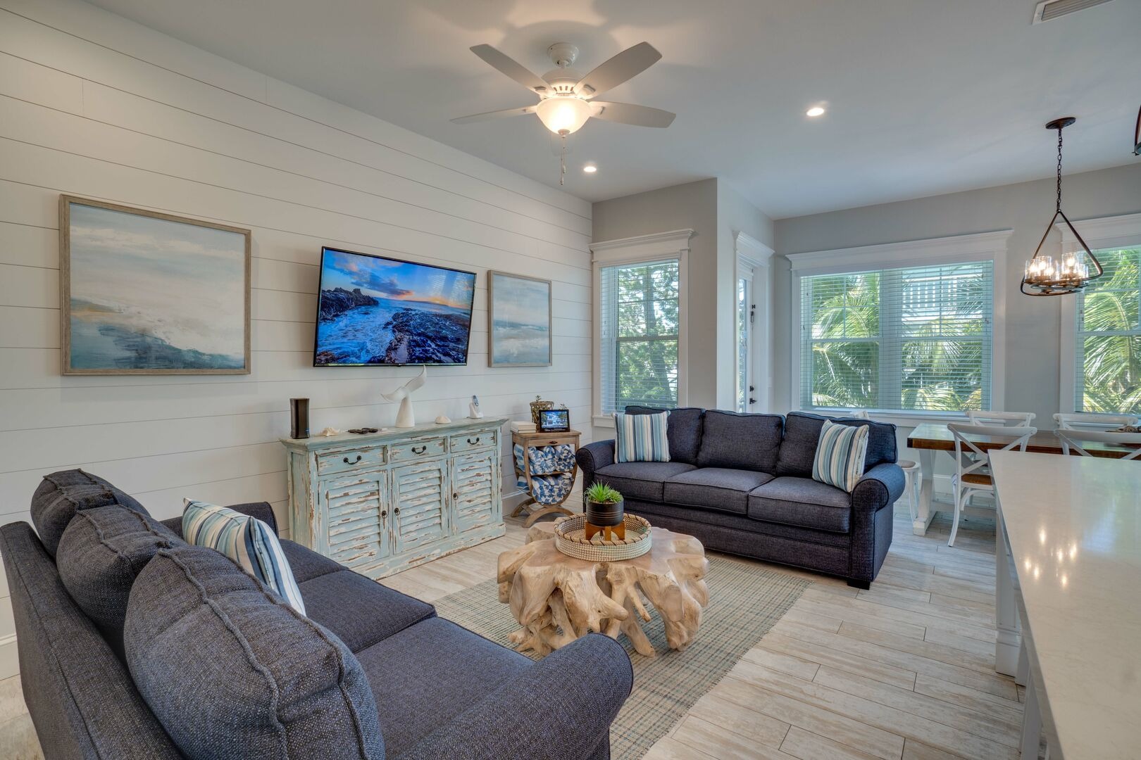 Bright living room with gray furniture and ocean view