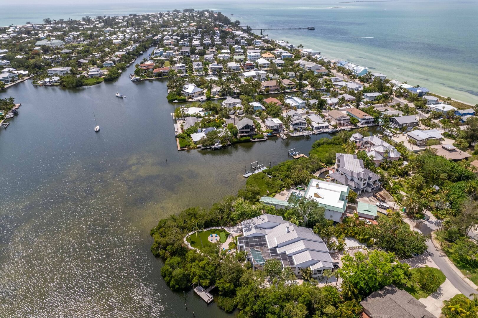Aerial view of residential waterfront community with green spaces