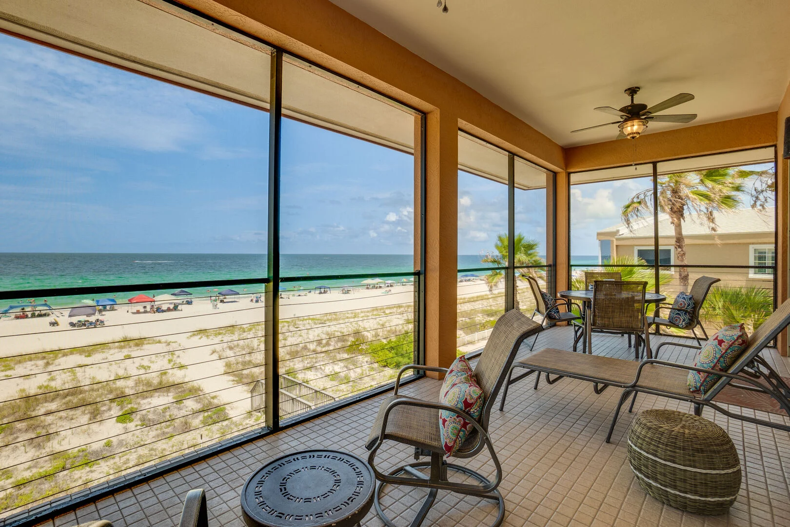 Beach and waterfront view from screened vacation rental porch
