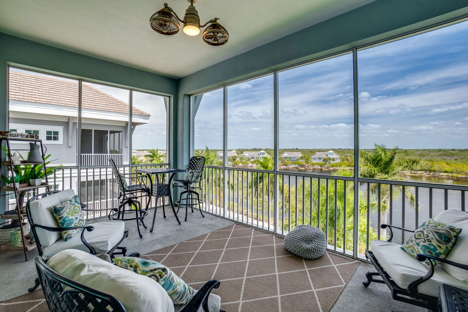 Covered balcony with lounge chairs and panoramic landscape views