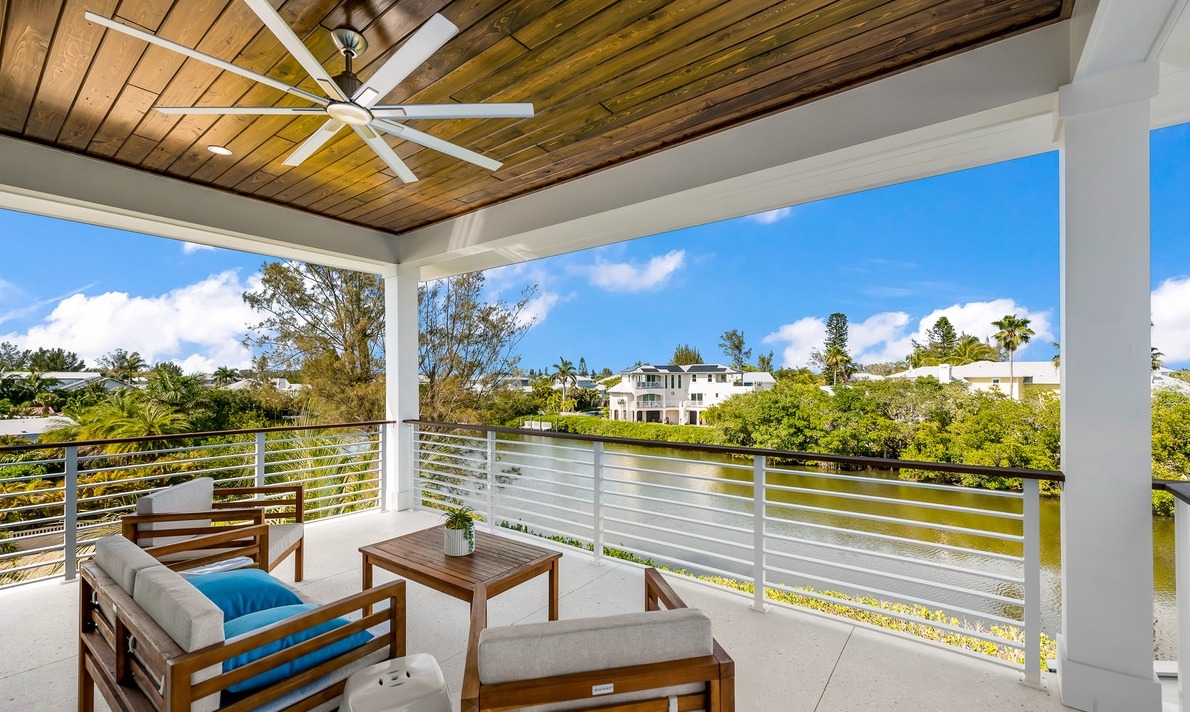Shaded patio with lounge chairs overlooking water