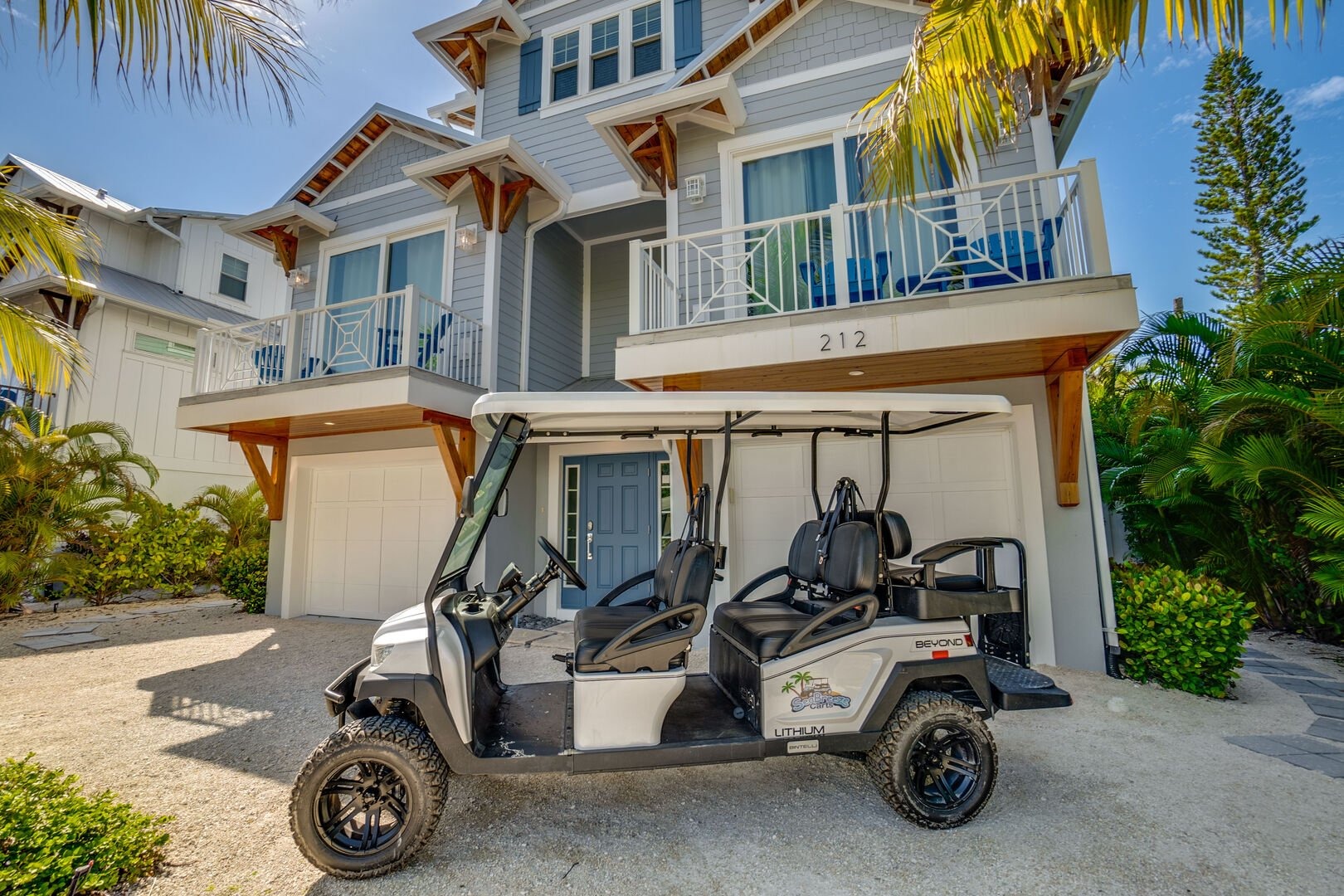 Vacation rental home with golf cart parked in driveway