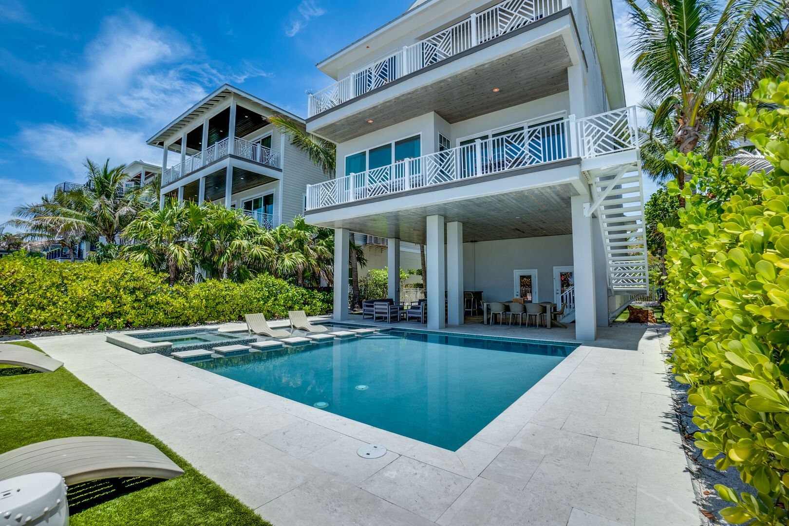 Modern waterfront home with infinity pool and deck