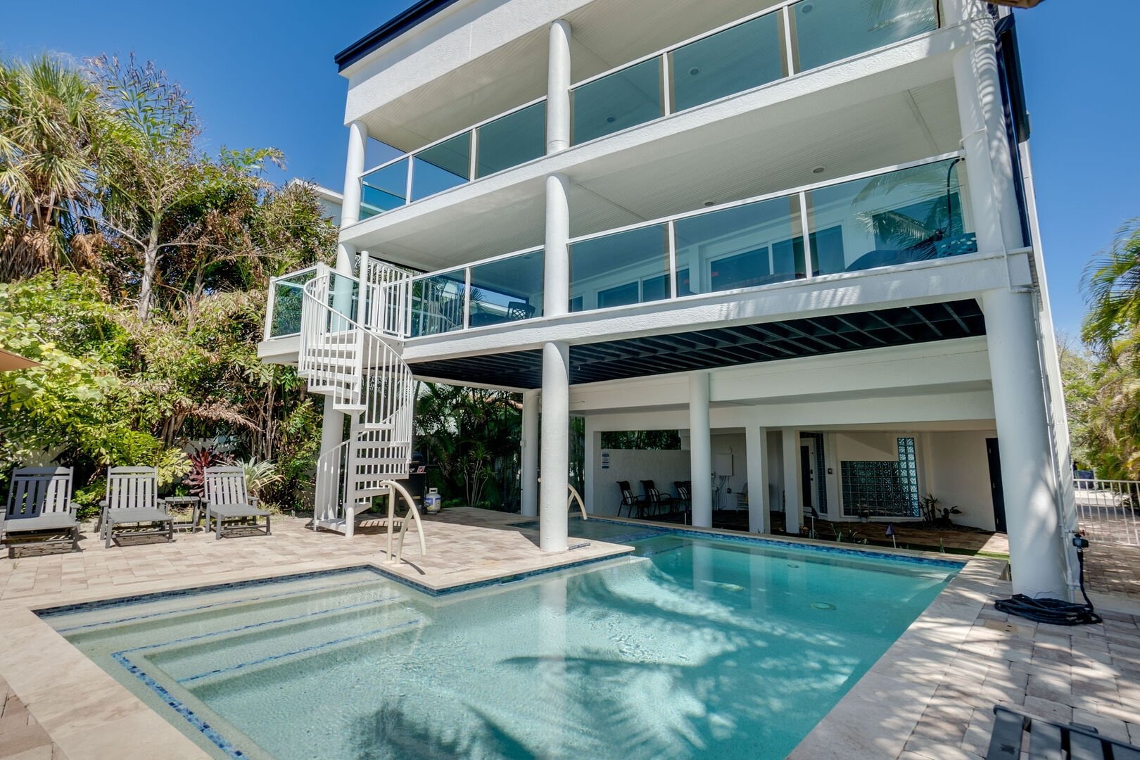 Contemporary multi-level beach home with large windows and pool