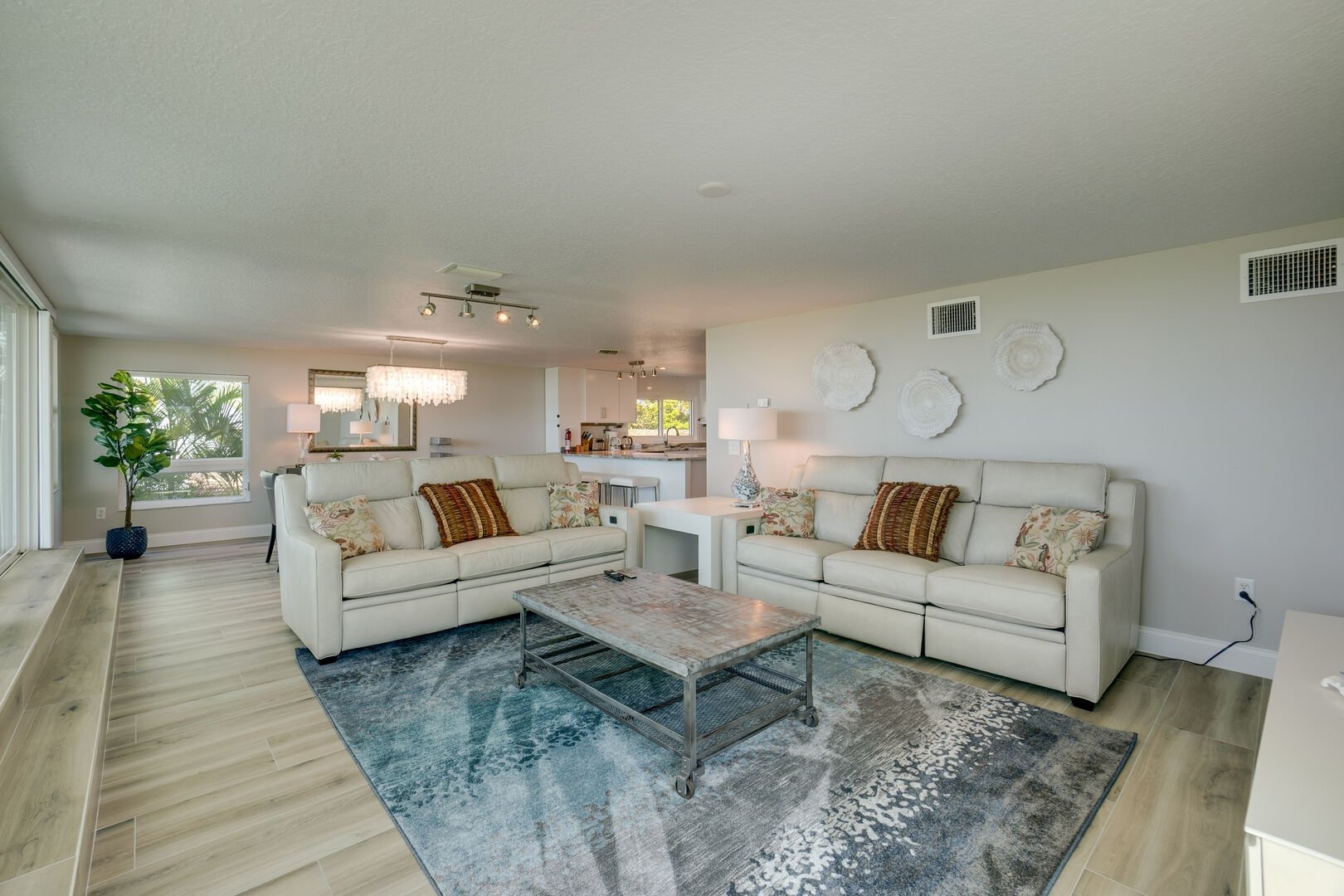 Modern living room with cream colored sofas and area rug
