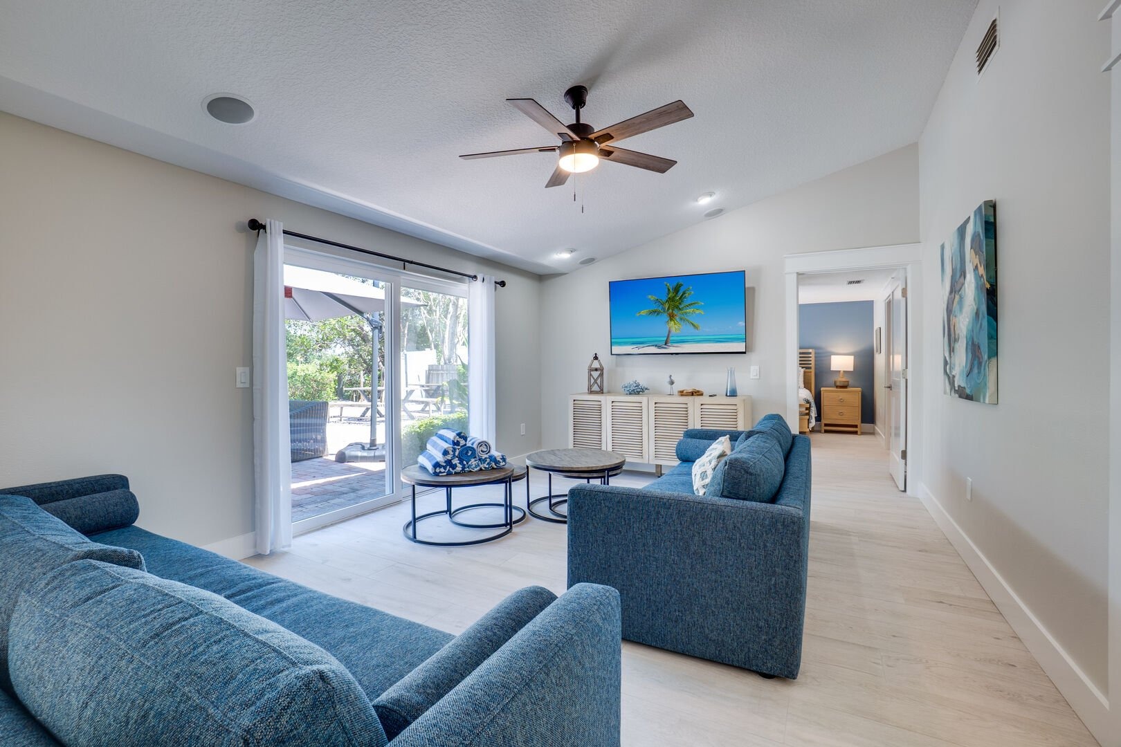 Contemporary living room with blue seating and sliding glass doors