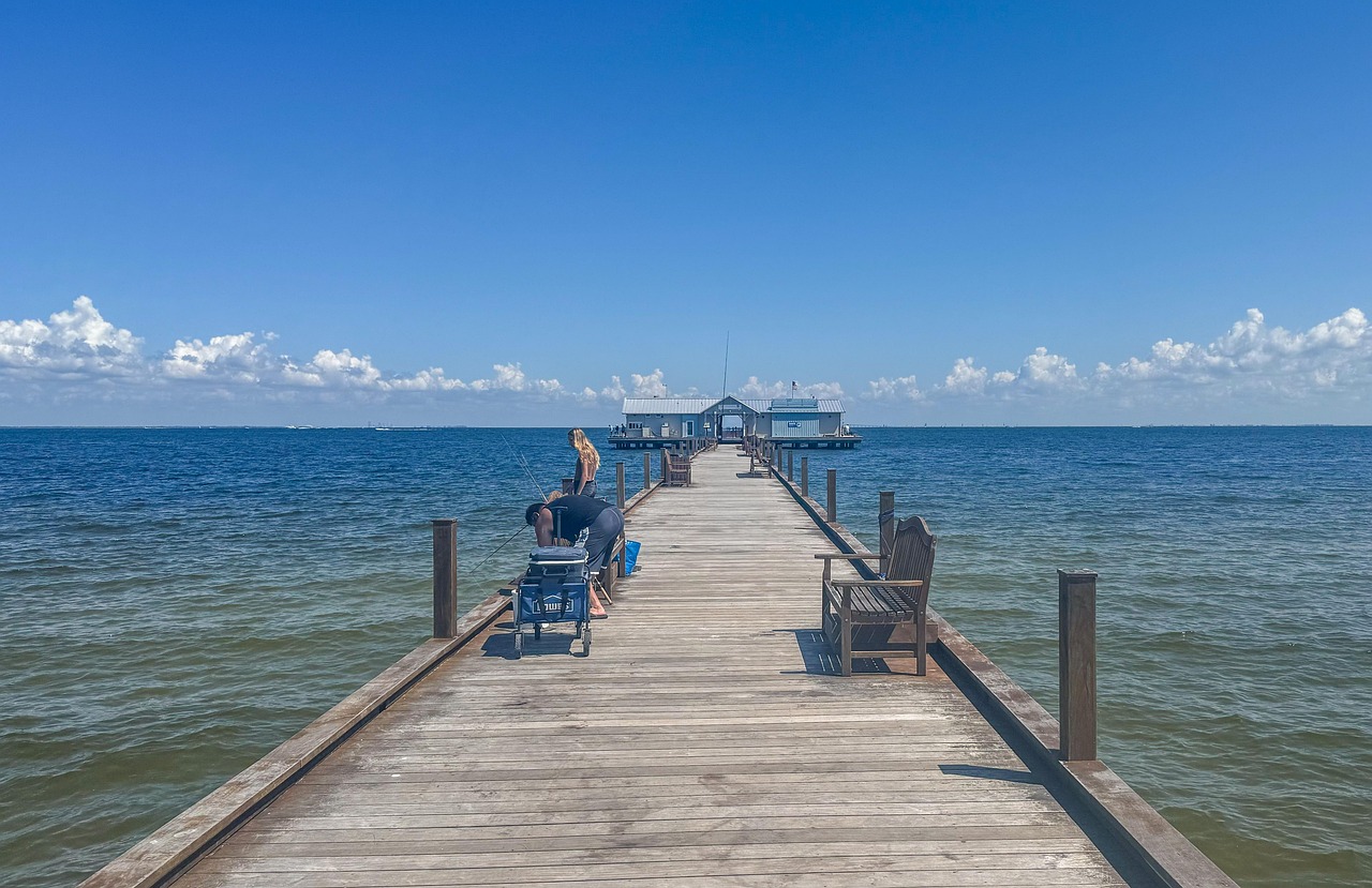 Wooden pier stretching into calm blue ocean water