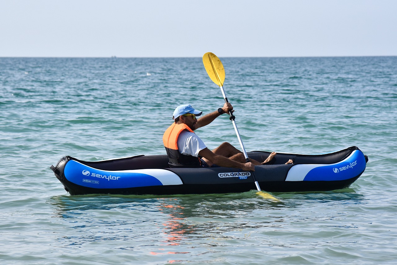 Man kayaking in shallow bay water
