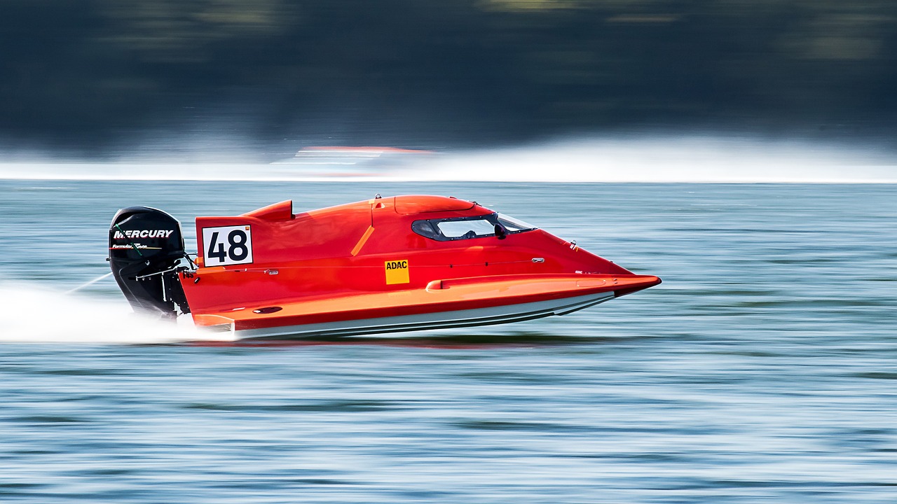 Red speedboat racing on water