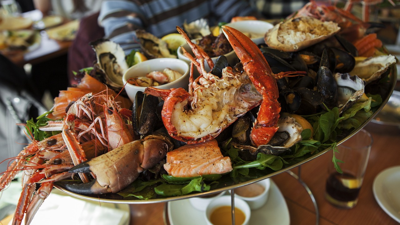 Fresh cooked lobster and seafood arranged on dinner plate